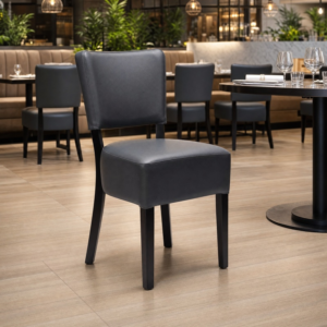 Alto FB Black Frame Fully Upholstered Dining Chair – in Black Faux Leather in restaurant setting