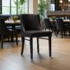 Camden Black Faux Leather Restaurant Dining Chair Black Frame in restaurant setting