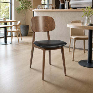Relish Side Chair – Walnut Stained Beech with Black Faux Leather Seat Pad in light cafe asetting